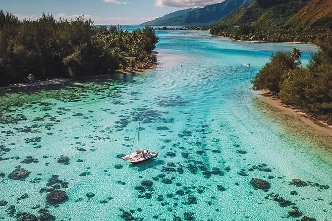 A catamaran anchored over the shallows inside the Moorea lagoon